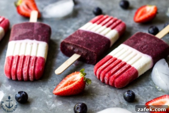 Close-up of Berry Cheesecake Popsicles showing distinct red, white, and blue layers.