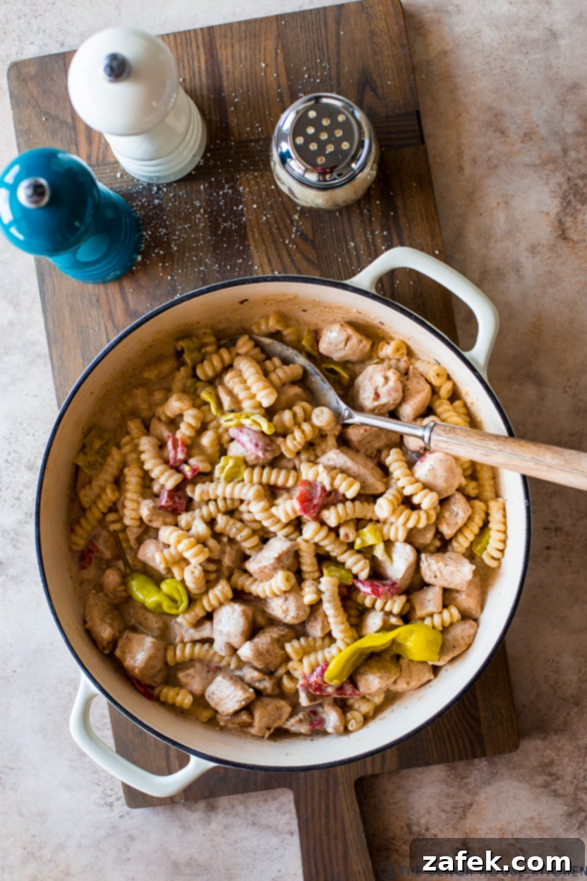 Overhead photo of a chicken pasta dish in a skillet, ready to be served