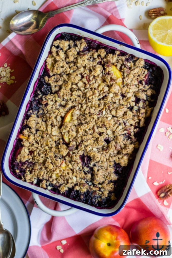 Delicious Gluten Free Blueberry Nectarine Crisp topped with vanilla ice cream