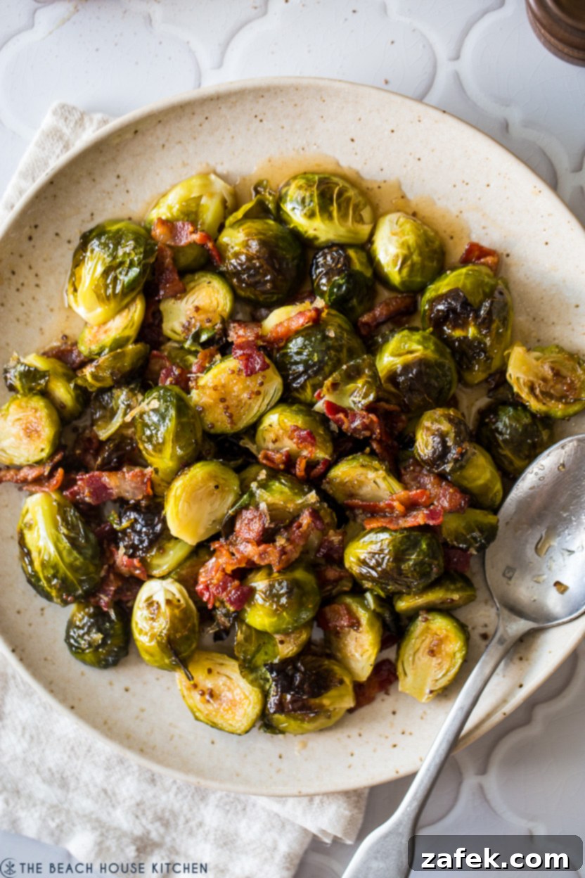 A close-up shot of perfectly roasted Brussels sprouts on a plate, showcasing their tender texture and golden-brown edges, ready for glazing.