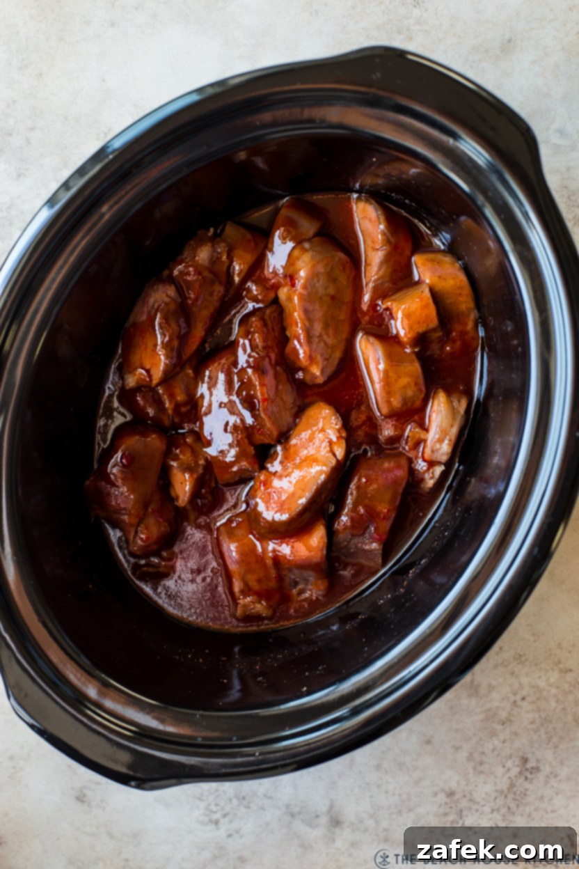 Overhead photo of a cooked slow cooker pork tenderloin, ready to be sliced.