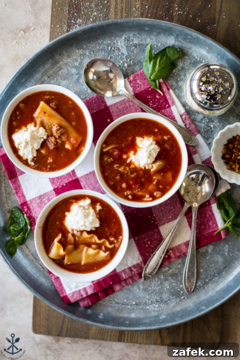 Hearty Lasagna Soup 7 Overhead photo of bowls of lasagna soup topped with dollops of ricotta cheese and basil