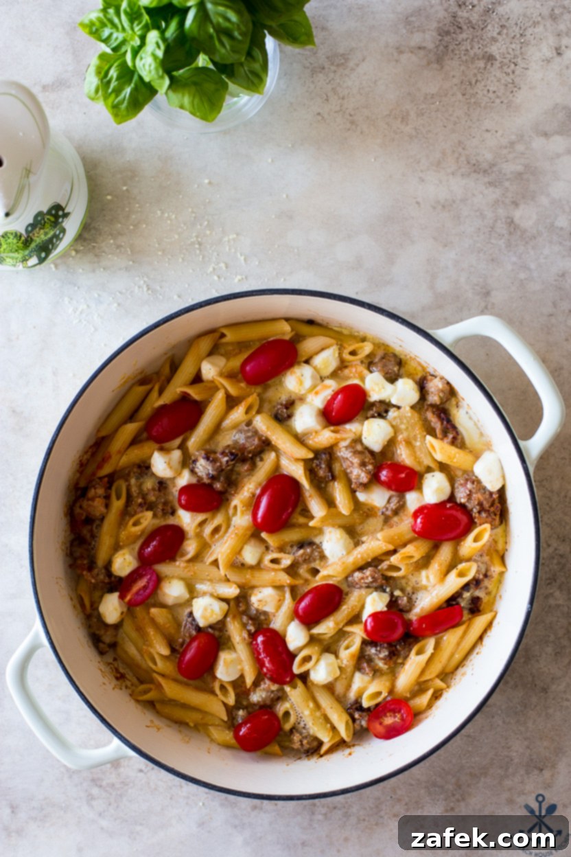 Italian Sausage & Pasta Frittata 11 Overhead photo of the pre-baked Italian Sausage Pasta Frittata, beautifully arranged with tomatoes, ready for the oven