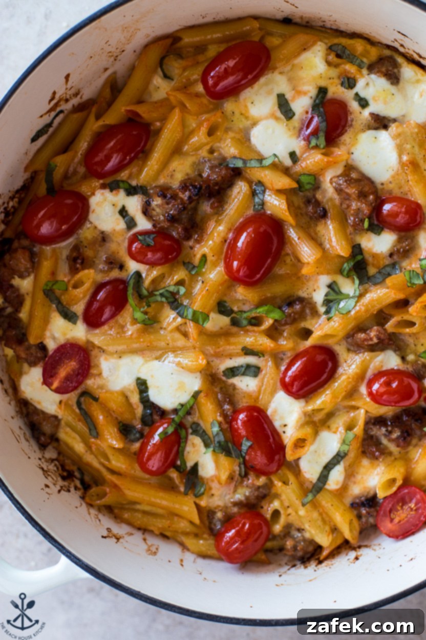 Italian Sausage & Pasta Frittata 12 Up close overhead photo of a pasta frittata slice on a rustic plate, garnished with basil
