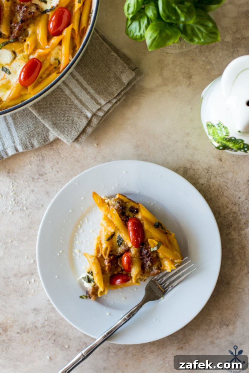 Italian Sausage & Pasta Frittata 5 Overhead photo of a perfectly portioned slice of Italian sausage pasta frittata, showcasing its layers and delicious golden crust