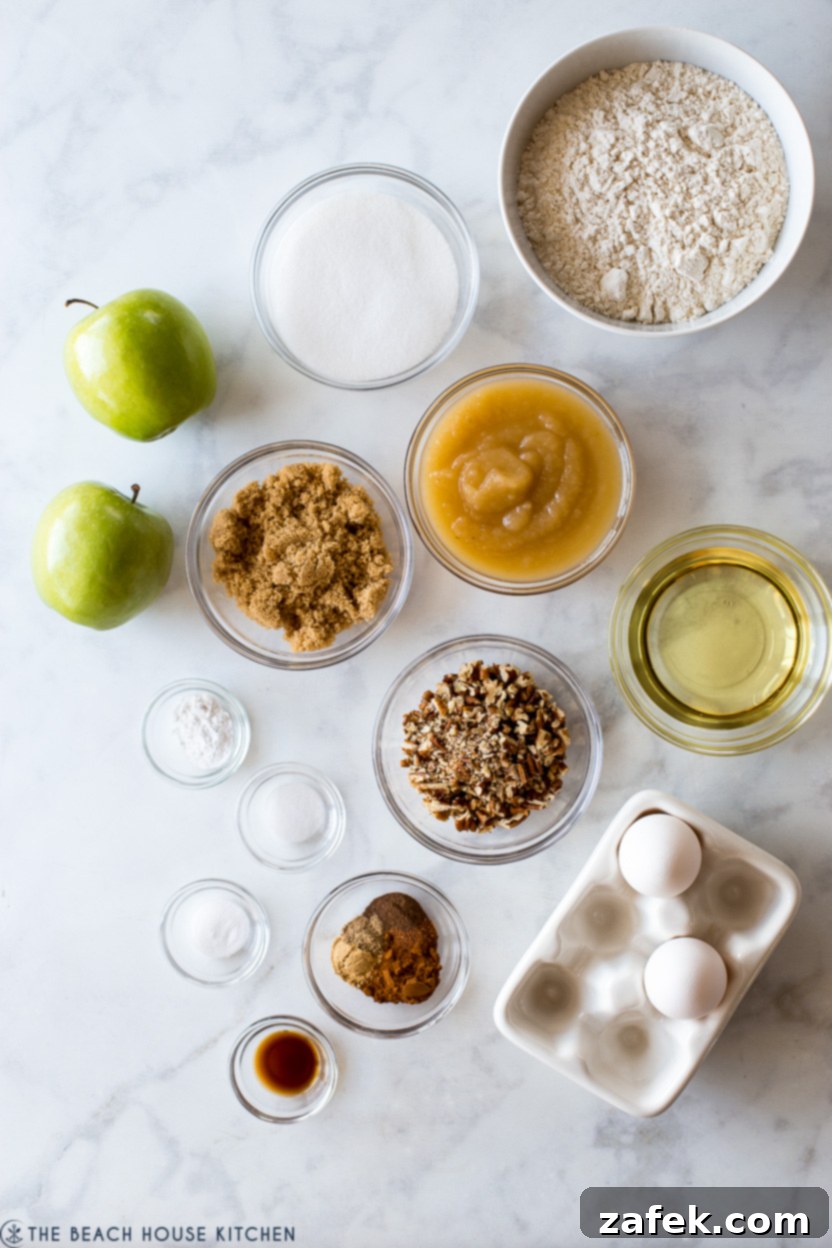 Overhead photo of ingredients for an apple spice cake recipe, including flour, spices, apples, and sugars