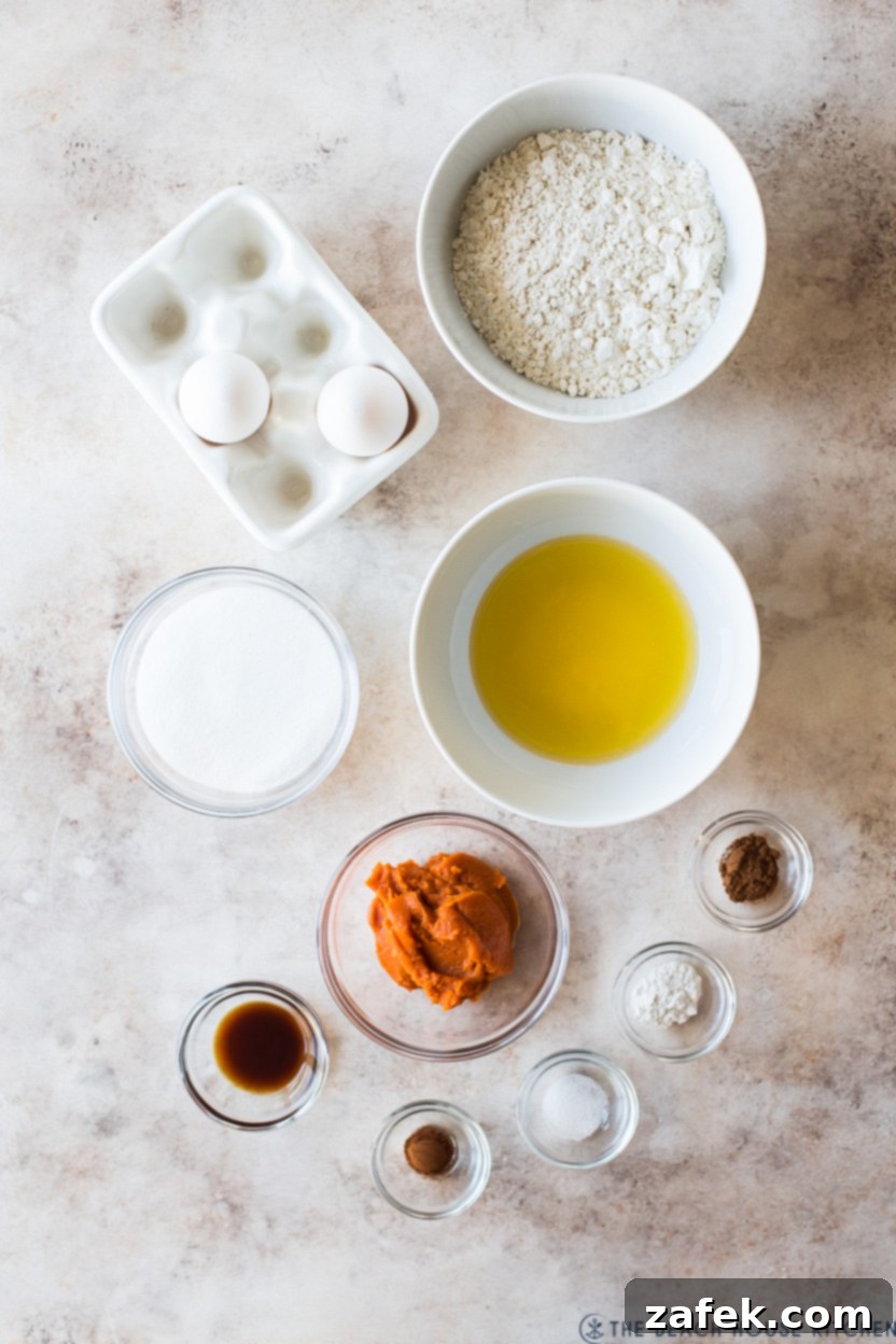 Autumn Spiced Pumpkin Madeleines 4 An inviting overhead photo displaying all the fresh, high-quality ingredients neatly arranged for baking delicious Pumpkin Madeleines.