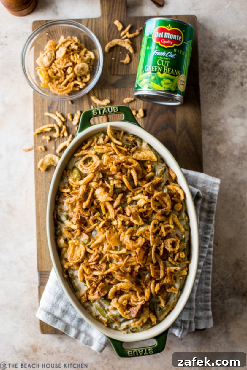 Overhead photo of a classic green bean casserole ready to be served on a wooden board