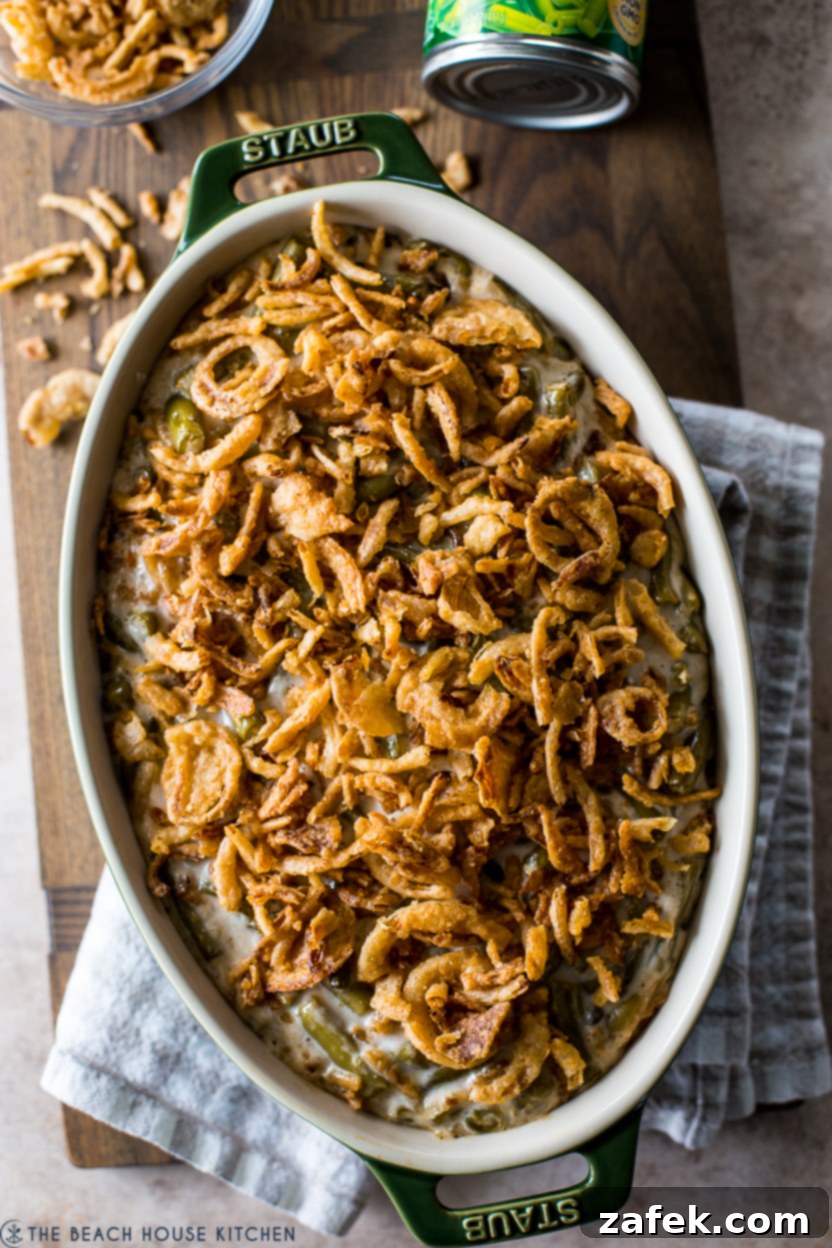Up close overhead photo of a creamy green bean casserole with crispy onion topping