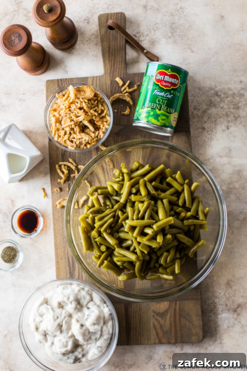 Overhead photo of ingredients for a classic green bean casserole: cream of mushroom soup, milk, soy sauce, green beans, and French fried onions