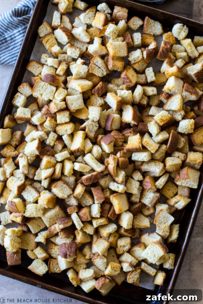 Golden Pineapple Stuffing 5 Overhead photo of two sheet pans filled with golden brown toasted Hawaiian bread pieces