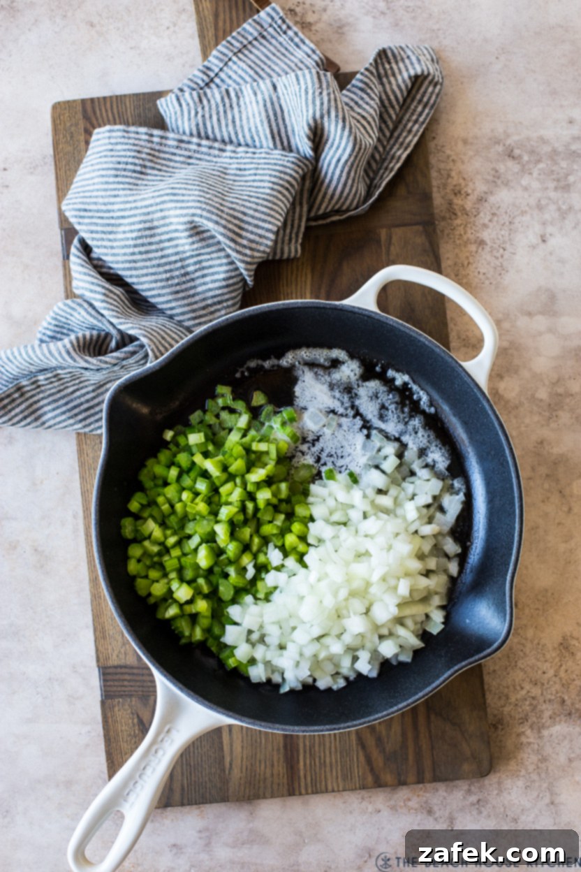 Golden Pineapple Stuffing 6 Overhead photo of a large skillet with chopped celery and yellow onions softening in melted butter