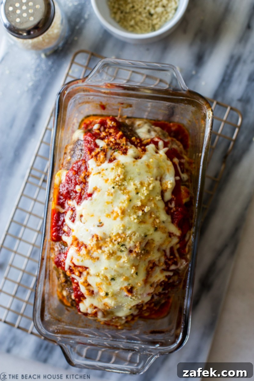 Overhead photo of a loaf pan with an Italian Meatloaf, rich with marinara and melted cheese.