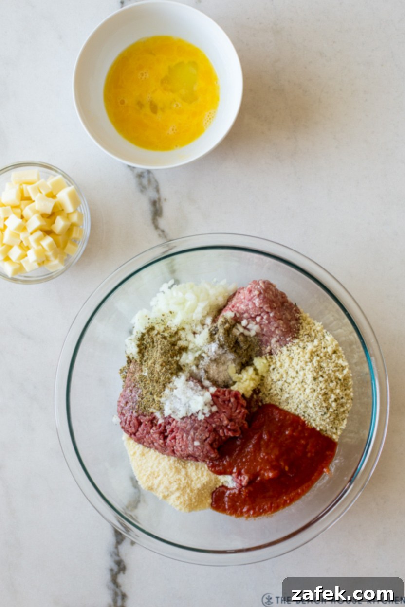 Overhead photo of a large mixing bowl filled with all the combined ingredients for an Italian meatloaf, ready to be shaped.