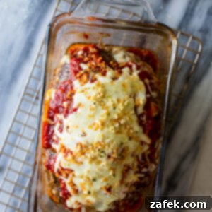 A perfectly cooked Italian Meatloaf in a loaf pan, ready to be sliced.