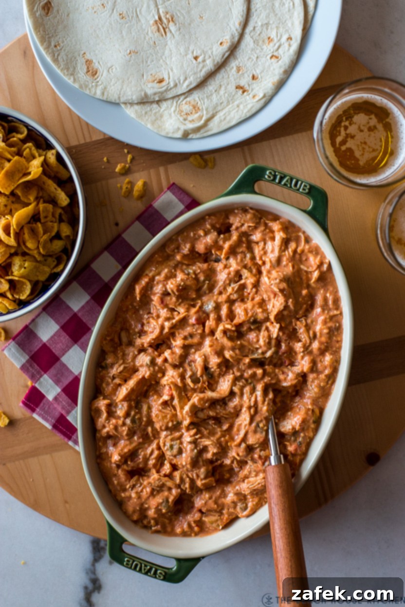 Overhead photo of an oval dish filled with a creamy taco chicken, garnished with fresh cilantro.