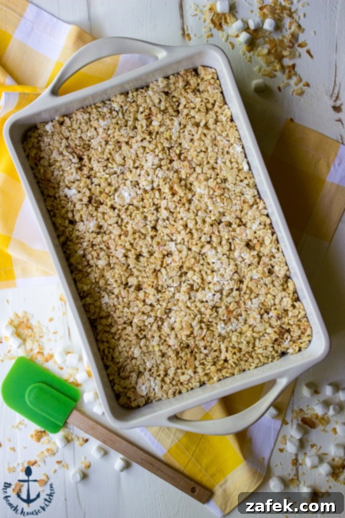 Close-up of Tropical Rice Krispy Treats showcasing Toasted Coconut and White Chocolate Drizzle