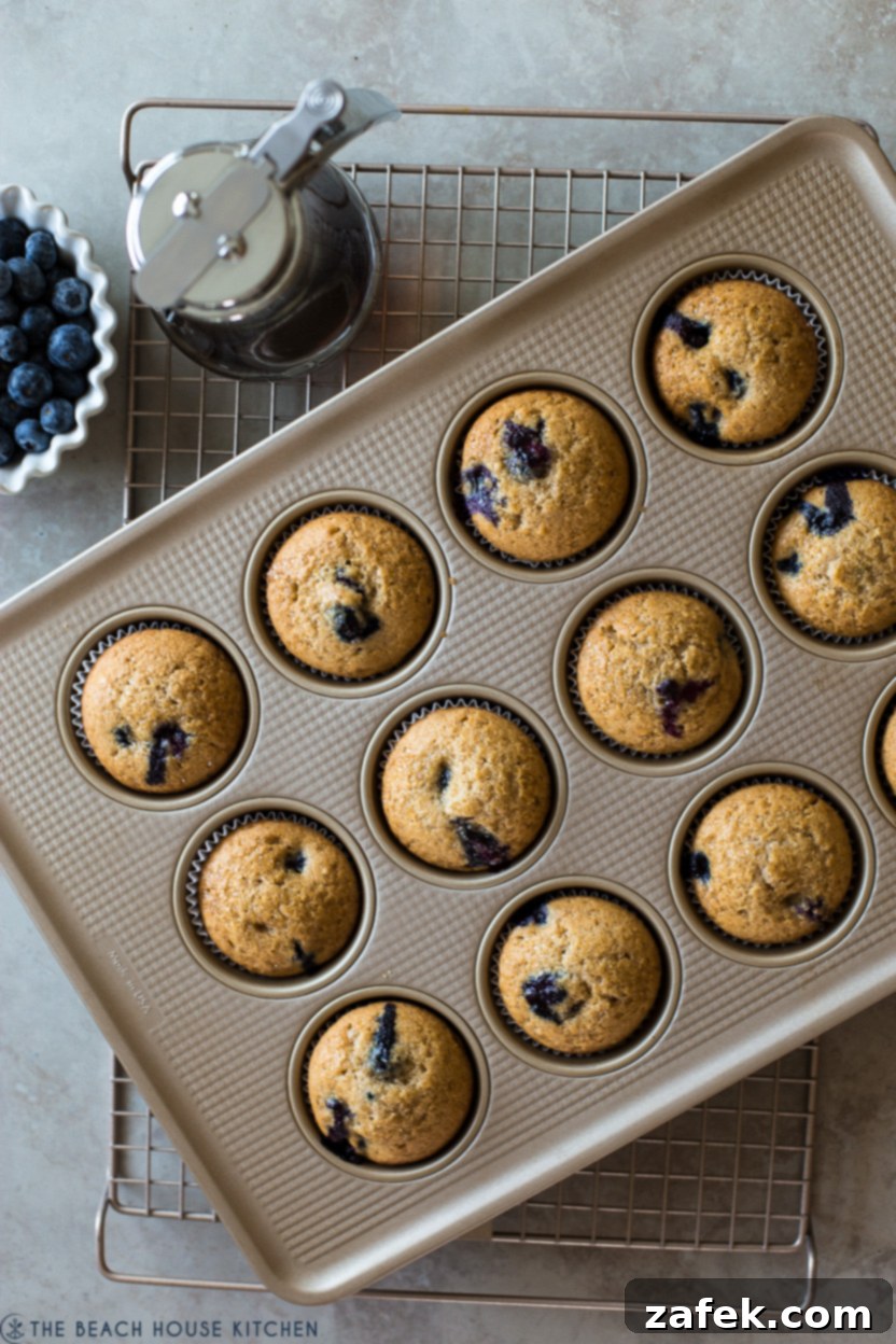 Sweet Maple Blueberry Pancake Muffins 2 Overhead photo of golden Maple Blueberry Pancake Muffins nestled in a muffin pan, ready to be enjoyed