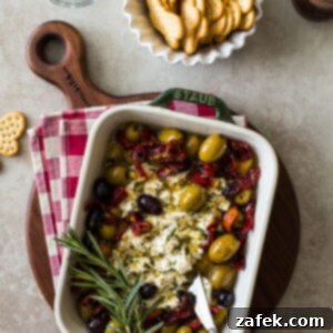 Delicious Baked Feta with Olives and Sun-dried Tomatoes in a baking dish, ready to be served.