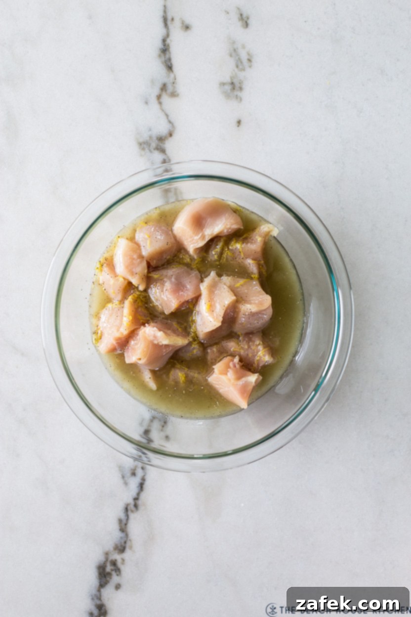 Overhead photo of a bowl filled with chicken chunks in a marinade