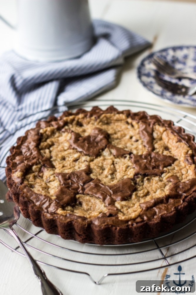 Decadent Peanut Butter Chocolate Chip Brookie Tart 3 Close-up of a slice of Peanut Butter Brookie Tart showing layers