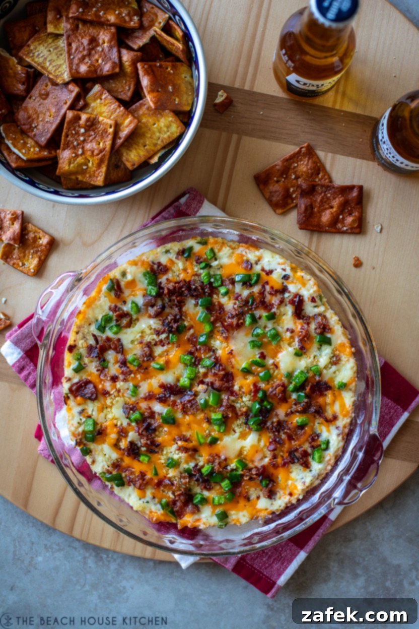 Loaded Jalapeño Popper Dip 8 Overhead photo of a jalapeno popper dip with a bowl of pretzel pita chips