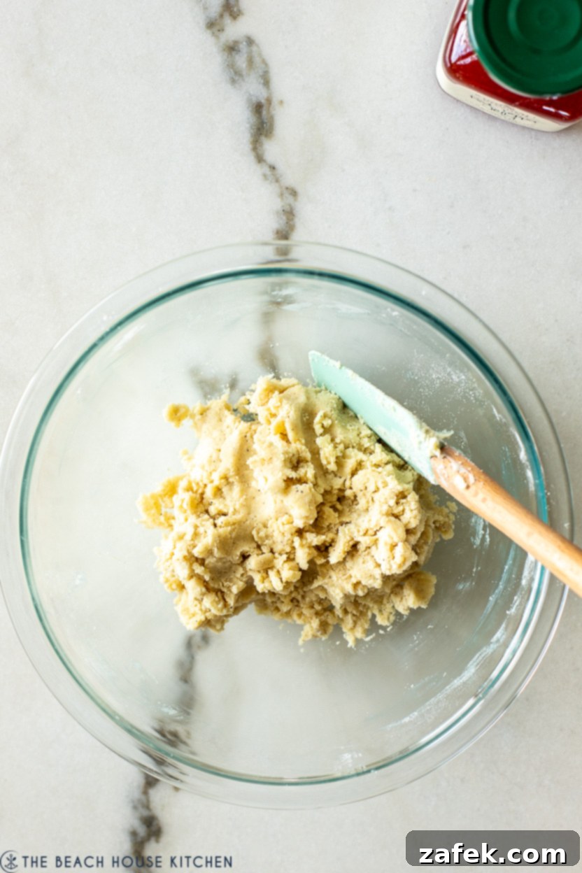 Overhead photo of a bowl filled with the prepared cheese dough for thumbprints, showing its smooth texture.