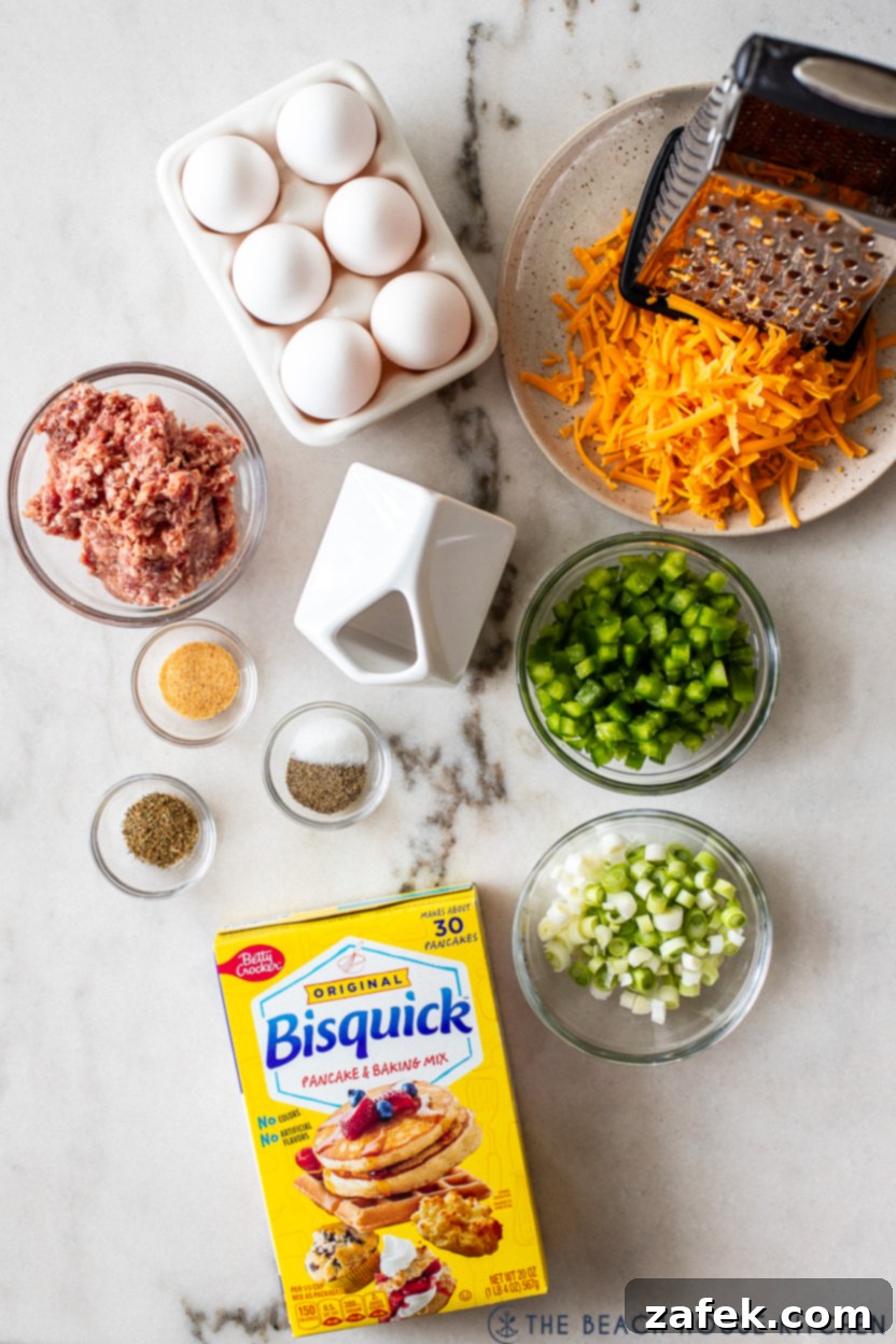 Overhead photo of all the raw ingredients laid out on a countertop, including sausage, eggs, bell pepper, onions, cheese, and seasonings, ready for preparation.