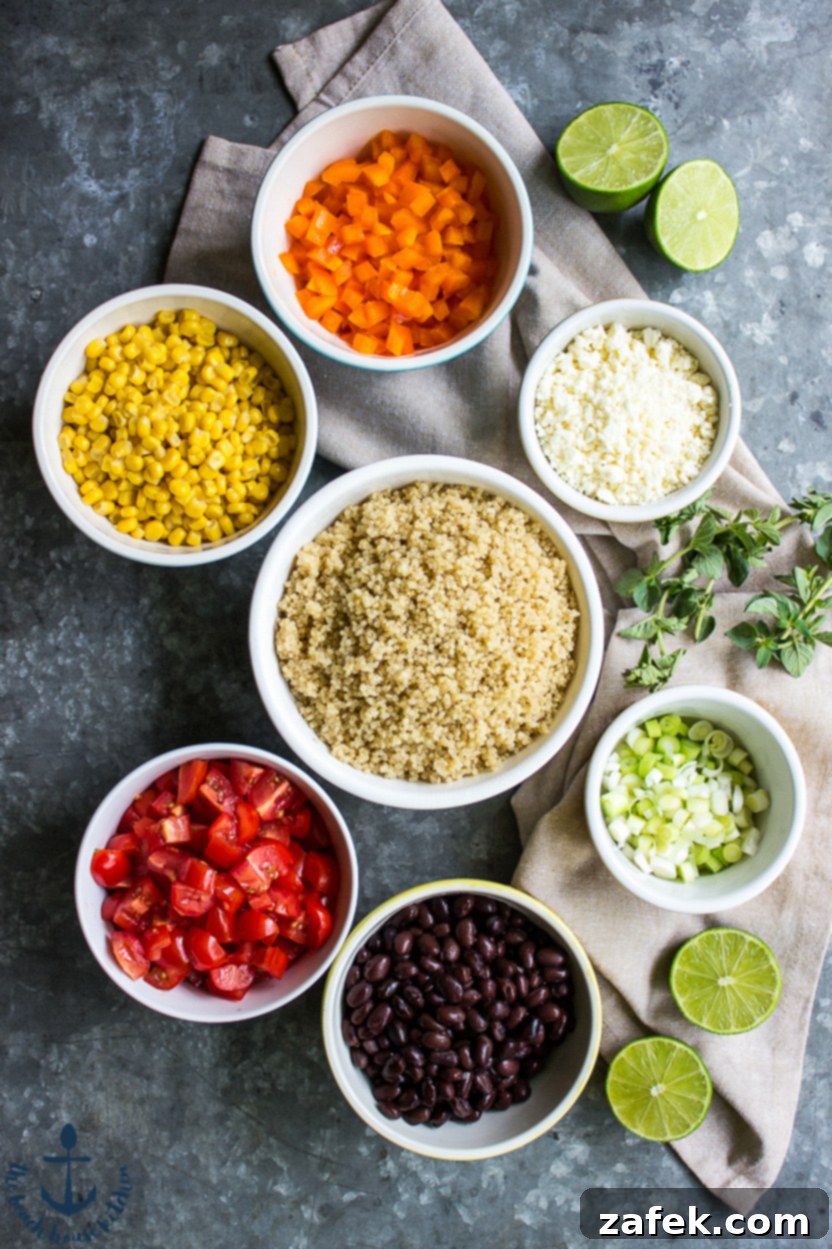Vibrant Southwest Quinoa Salad with Tangy Lime and Cotija 4 Overhead photo displaying all the fresh, colorful ingredients for a Southwestern Quinoa Salad, arranged in separate bowls on a gray background, prior to assembly.