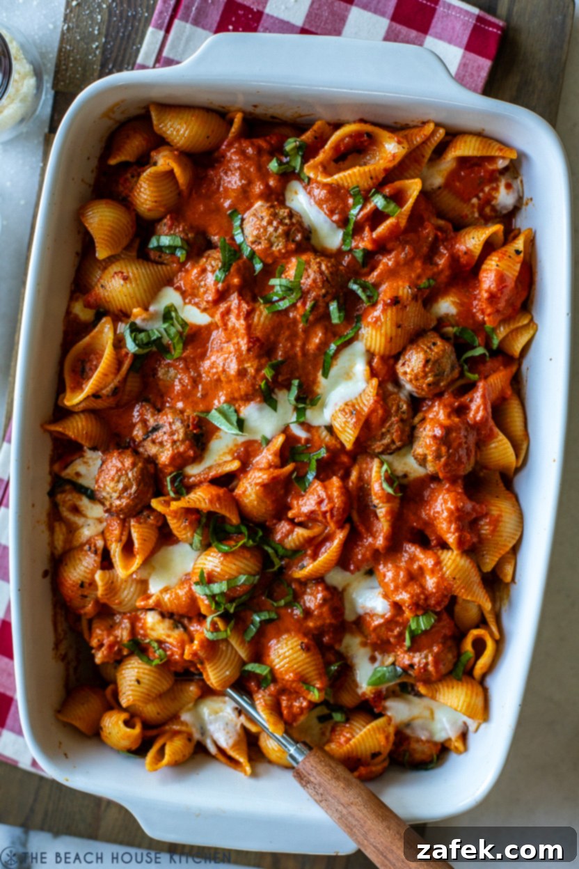 Delicious Easy Meatball Pasta Bake topped with fresh basil