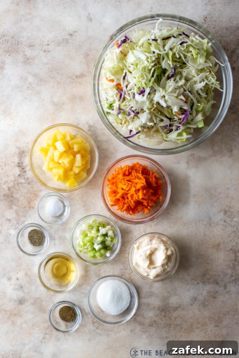 Overhead photo of fresh ingredients for pineapple coleslaw laid out on a clean surface