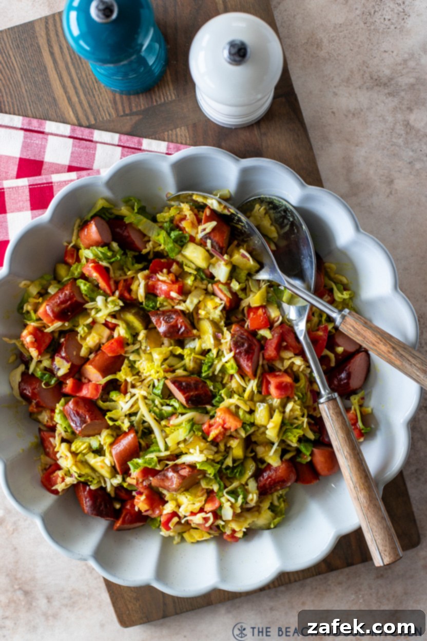 Overhead photo of a large, rustic serving dish generously filled with Chicago Hot Dog Salad, showcasing its colorful ingredients and inviting texture. Ideal for family meals or a summer potluck.