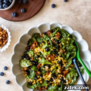 A beautifully presented Blueberry Corn Salad on a white plate, ready to be served.