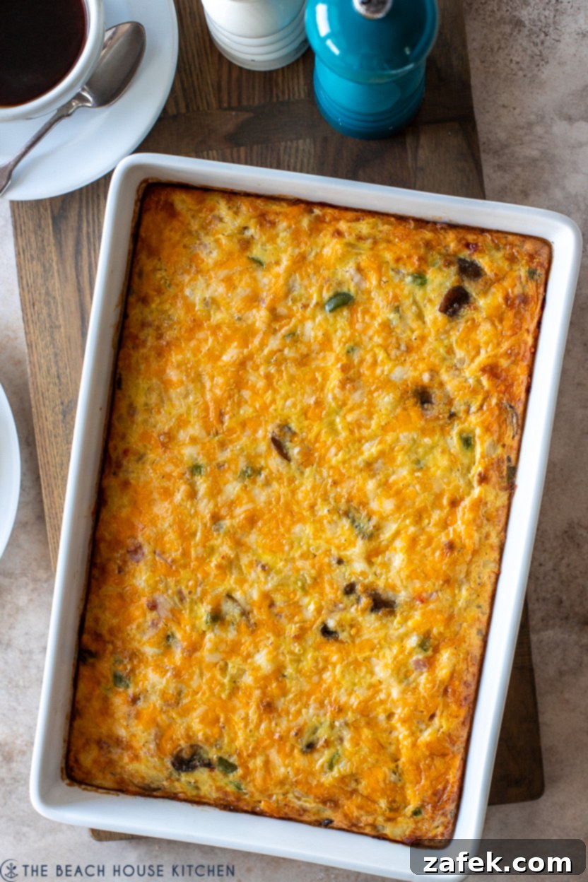 Golden Ham and Veggie Hash Brown Bake 9 Up close overhead photo of a ham and vegetable hash brown breakfast casserole, showing the texture and delicious ingredients.