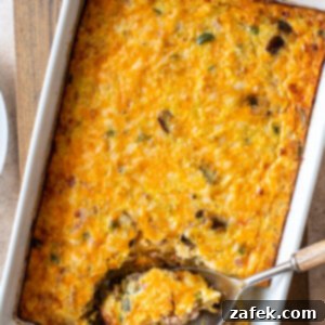 Golden Ham and Veggie Hash Brown Bake 10 A close-up shot of the finished Ham and Vegetable Hash Brown Breakfast Casserole, garnished and steaming hot.