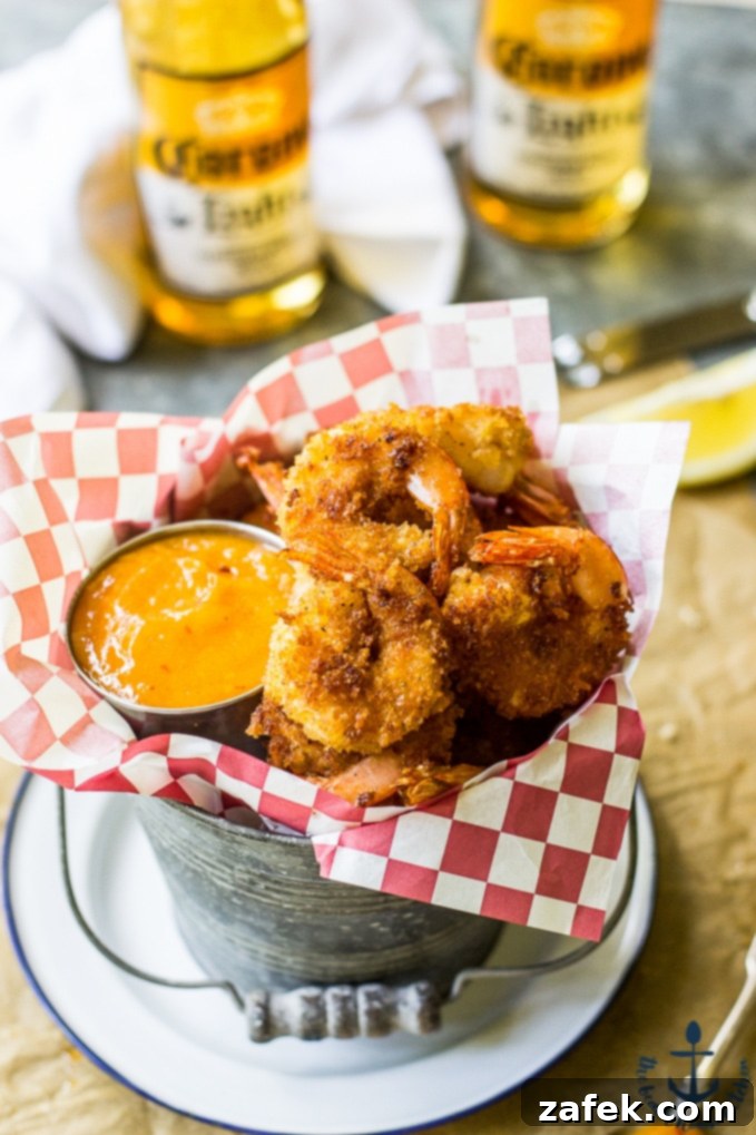 Mango Chipotle Glazed Popcorn Shrimp 5 Mango Chipotle Sauce in a small bowl with Popcorn Shrimp