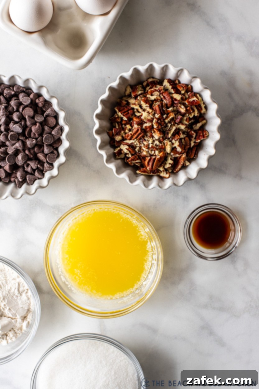 Ultimate Chocolate Chip Delight 4 A close-up overhead view of melted butter, granulated sugar, all-purpose flour, pecan halves, chocolate chips, and eggs, the key ingredients for an easy chocolate chip pie.