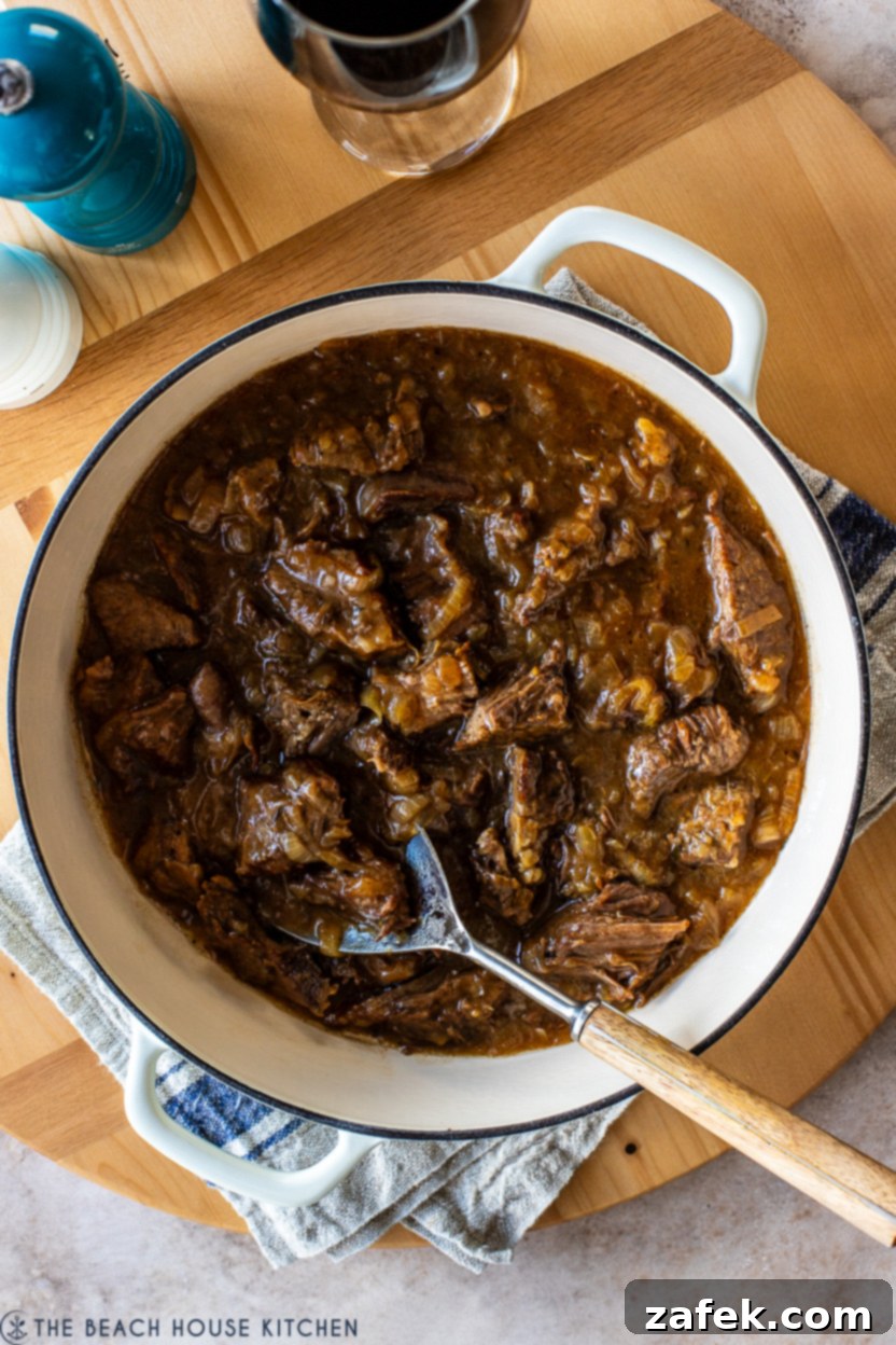 Overhead photo of a Dutch oven filled with a French Onion pot roast, ready to be served