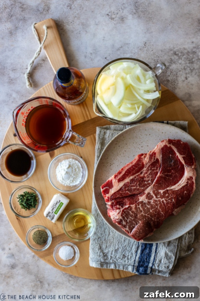 Overhead photo showcasing the fresh ingredients laid out for a French Onion pot roast, including onions, beef, herbs, and spices
