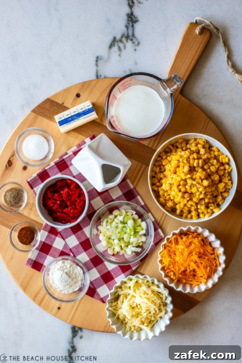 Overhead photo of ingredients for pimento cheese creamy corn, including butter, green onions, flour, cheeses, pimentos, and canned corn.
